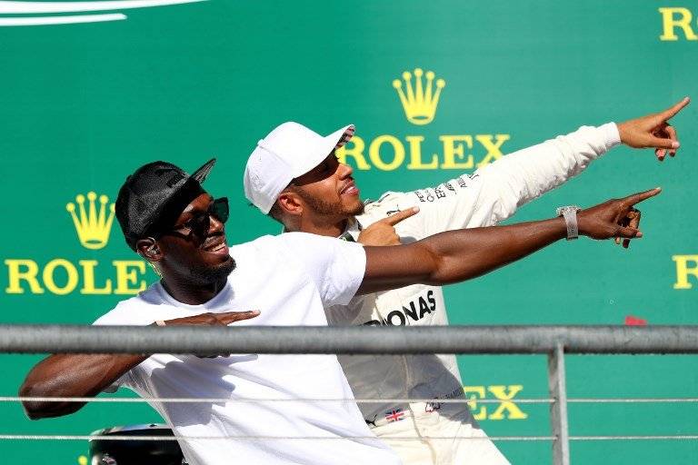 Usain Bolt junto a Lewis Hamilton