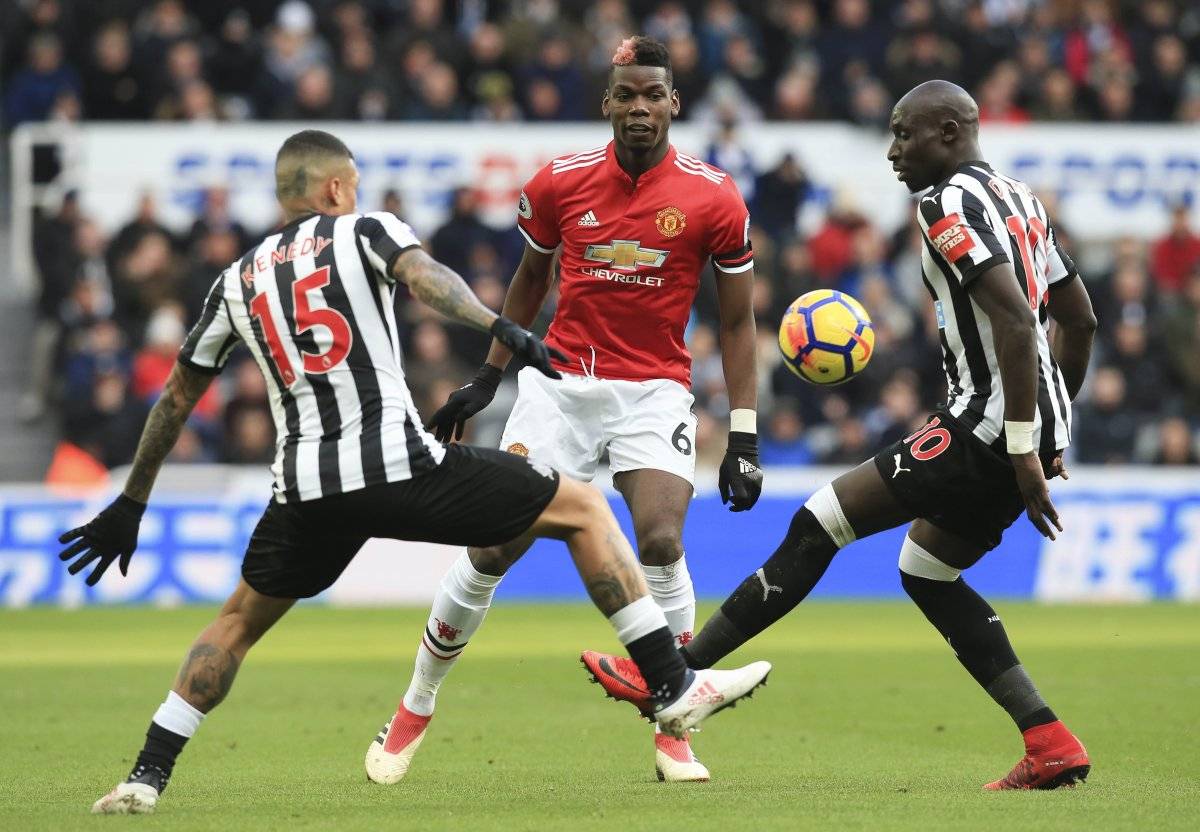 Paul Pogba no puede ante la marca de dos adversarios.