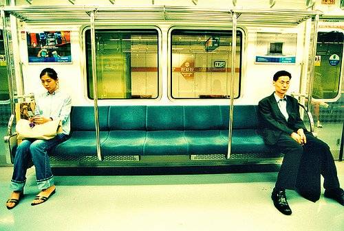 koreanmanandwomansittingapartonsubway.jpg