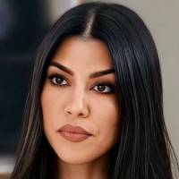 Kourtney Kardashian cautiva en crop top de seda beige y pants blancos a la cintura