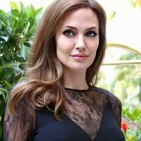 Angelina Jolie enamora en un vestido tipo suéter de cuello tortuga y con botines de cuero en un look de otoño coqueto