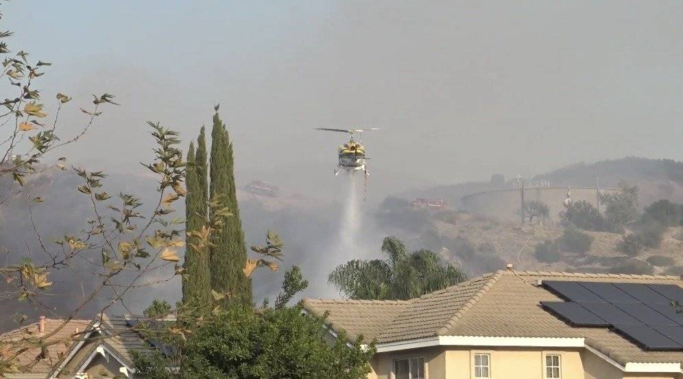helicópteros lanzan agua en los incendios mientras evacuan a miles de personas en el condado de Orange